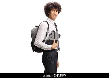 Cute young schoolboy with books and backpack pointing up isolated on ...
