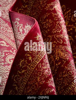 Rich red Persian carpet with detailed golden floral patterns, luxurious texture Stock Photo