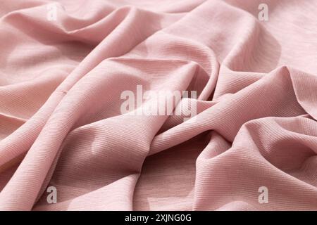 Soft and elegant pink fabric with a subtle texture, ideal for fashion and decor. Stock Photo