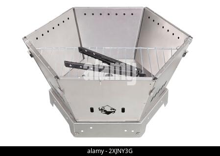 Hexagonal metal fire pit with grilling accessories. Stock Photo