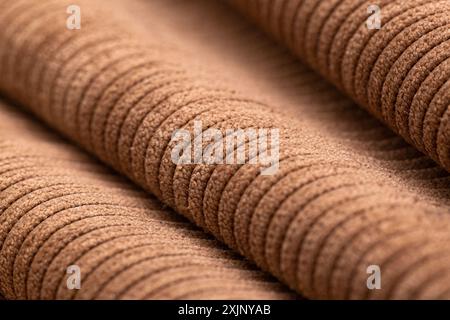 Close-up of brown textured fabric rolls. Stock Photo