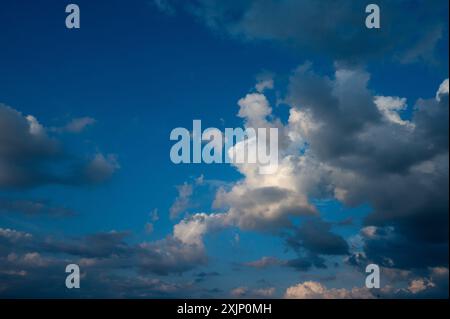 Evening sky in summer with cumulus clouds and wispy clouds Stock Photo