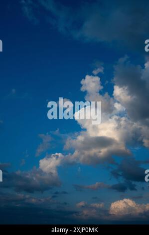 Evening sky in summer with cumulus clouds and wispy clouds Stock Photo