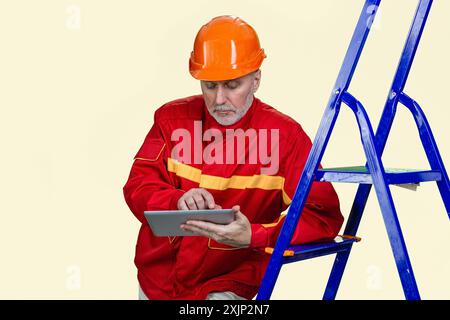 Portrait of mature contruction worker is using a tablet pc device. Isolated on white. Stock Photo