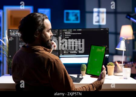 Admin using isolated screen tablet to filter malicious traffic from cybercriminals attempting to corrupt company data. IT expert working on mockup portable device, preventing malware attacks Stock Photo