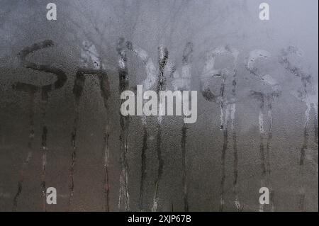 Sadness is a concept. background lettering on glass Stock Photo