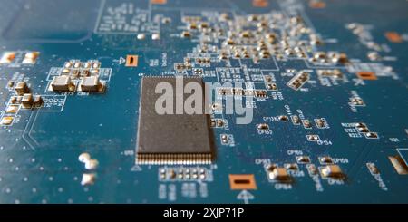 Close up of semiconductor chip on mainboard with blue high tech pattern. Selected focus. Stock Photo