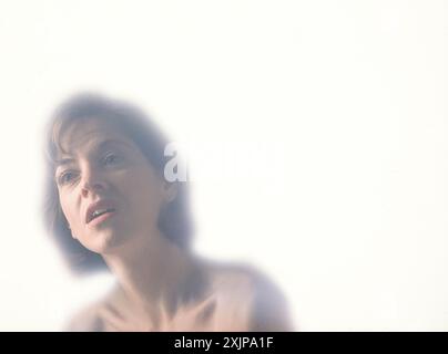 Portrait of a Woman with a painful expression on a white background Stock Photo