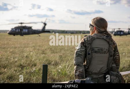 An Iowa Army National Guard Soldier assigned to the 1st Battalion, 168th Infantry Regiment, 2nd Brigade Combat Team, 34th Infantry Division, waits to board a UH-60 Black Hawk helicopter during an air assault exercise at Camp Ripley, Minn., on July 18, 2024. The 2/34th IBCT is completing an eXportable Combat Training Capabilities rotation, which trains Soldiers in dynamic and challenging scenarios and certifies their platoon proficiencies. (U.S. Army National Guard photo by Sgt. 1st Class Tawny Kruse) Stock Photo