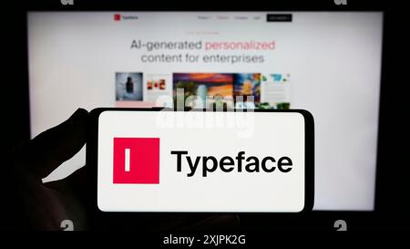 Stuttgart, Germany, 07-08-2023: Person holding smartphone with logo of US artificial intelligence company Typeface Inc. on screen in front of Stock Photo