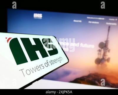 Stuttgart, Germany, 07-08-2023: Smartphone with logo of telecommunications company IHS Holding Limited on screen in front of website. Focus on Stock Photo