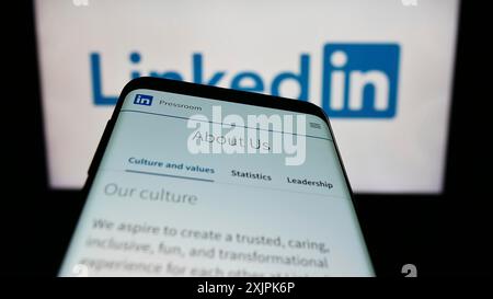 Stuttgart, Germany, 07-09-2023: Mobile phone with website of US social media company LinkedIn Corporation on screen in front of logo. Focus on Stock Photo
