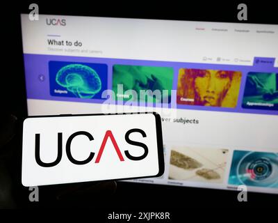 Stuttgart, Germany, 07-09-2023: Person holding smartphone with logo of Universities and Colleges Admissions Service (UCAS) on screen in front of Stock Photo