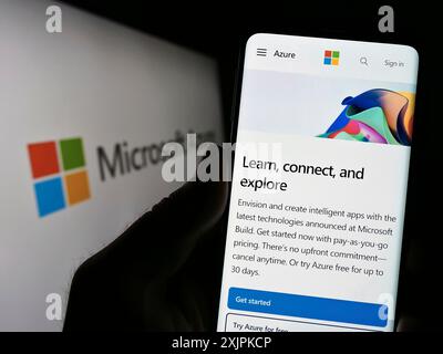Stuttgart, Germany, 07-11-2023: Person holding smartphone with website of cloud computing platform Microsoft Azure on screen in front of logo. Focus Stock Photo