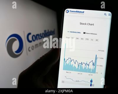 Stuttgart, Germany, 07-15-2023: Person holding cellphone with webpage of company Consolidated Communications Holdings Inc. on screen with logo. Focus Stock Photo