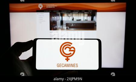 Stuttgart, Germany, 07-27-2023: Person holding cellphone with logo of Congolese mining company Gecamines on screen in front of business webpage. Stock Photo