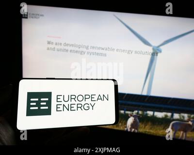 Stuttgart, Germany, 07-27-2023: Person holding cellphone with logo of Danish renewables company European Energy AS on screen in front of webpage. Stock Photo