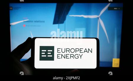 Stuttgart, Germany, 07-27-2023: Person holding smartphone with logo of Danish renewables company European Energy AS on screen in front of website. Stock Photo