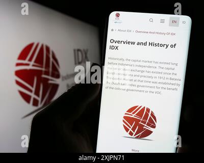 Stuttgart, Germany, 08-02-2023: Person holding cellphone with website of financial market Indonesia Stock Exchange (IDX) on screen with logo. Focus Stock Photo