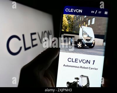 Stuttgart, Germany, 08-05-2023: Person holding cellphone with webpage of Estionian autonomous vehicle company Clevon AS on screen with logo. Focus on Stock Photo