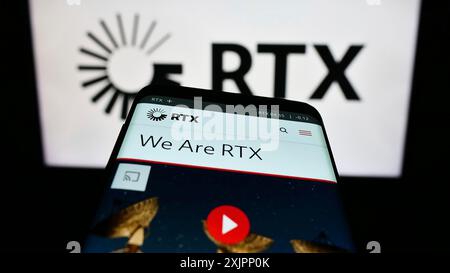 Stuttgart, Germany, 08-06-2023: Smartphone with webpage of US aerospace and defense company RTX Corporation on screen in front of logo. Focus on Stock Photo