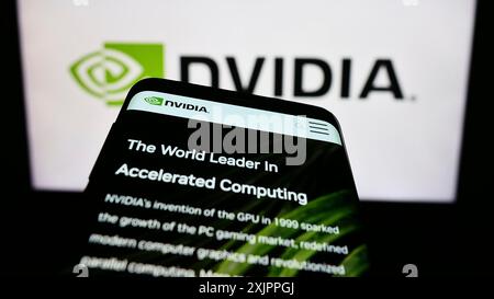 Stuttgart, Germany, 08-13-2023: Mobile phone with website of US technology company Nvidia Corporation on screen in front of business logo. Focus on Stock Photo