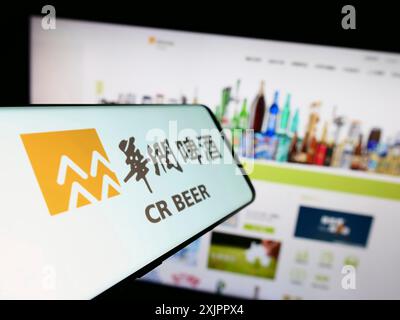 Smartphone with logo of business China Resources Beer Holdings Co 