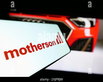 Stuttgart, Germany, 08-28-2023: Cellphone with logo of company Samvardhana Motherson International Ltd. on screen in front of website. Focus on Stock Photo