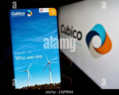 Stuttgart, Germany, 08-28-2023: Person holding cellphone with webpage of company Cubico Sustainable Investments Limited on screen with logo. Focus on Stock Photo