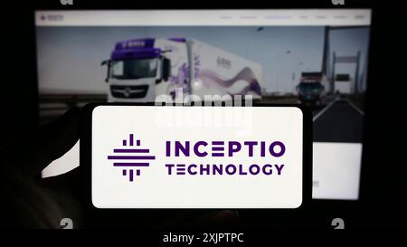 Stuttgart, Germany, 09-07-2023: Person holding smartphone with logo of autonomous vehicle company Inceptio Technology on screen in front of website. Stock Photo