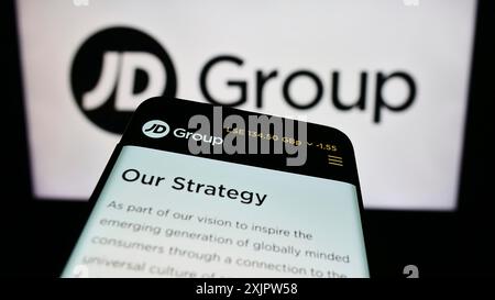 Stuttgart, Germany, 09-19-2023: Mobile phone with website of British retail company JD Sports Fashion plc on screen in front of business logo. Focus Stock Photo