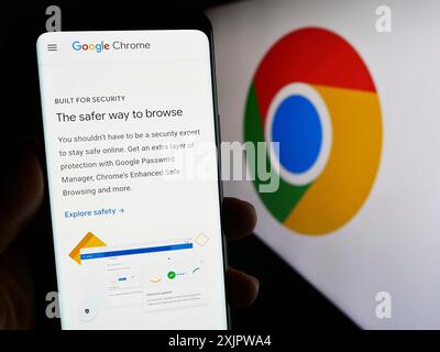 Stuttgart, Germany, 09-22-2023: Person holding smartphone with webpage of web browser Google Chrome on screen in front of business logo. Focus on Stock Photo