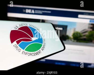 Stuttgart, Germany, 11-11-2023: Smartphone with seal of United States Drug Enforcement Administration (DEA) in front of website. Focus on center of Stock Photo