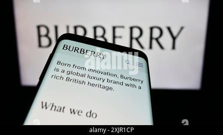 Stuttgart, Germany, 11-21-2023: Mobile phone with website of British luxury fashion company Burberry Group plc in front of business logo. Focus on Stock Photo