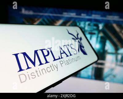 Stuttgart, Germany, 12-07-2023: Cellphone with webpage of company Impala Platinum Holdings Limited (Implats) in front of logo. Focus on center-left Stock Photo