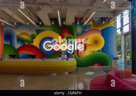 Google sign on the wall behind the reception desk at the Google headquarters in Silicon Valley Stock Photo