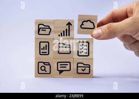 Wooden block icon represents digital document management system for remote access to files in a corporate office setting. Stock Photo