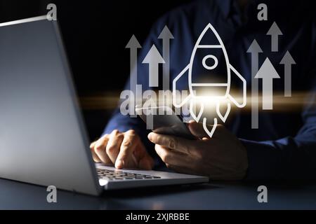 Launching a Tech Startup: Young Caucasian Man Using Smartphone to Plan Business Strategy and Improve Company Growth Stock Photo