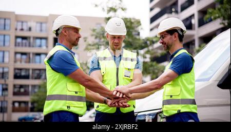 United Team of Professionals Building Success on Construction Site: Architects, Engineers, Workers, Inspectors, and Contractors Collaborate for Develo Stock Photo