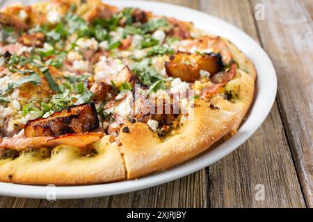 A view of an eggplant and ham pizza pie. Stock Photo