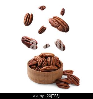 Pecan nuts falling into bowl on white background Stock Photo