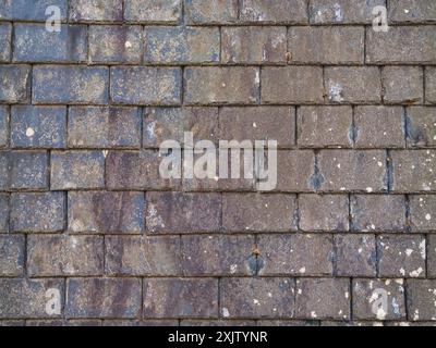 Rows of grey, weathered slate roofing tiles. Stock Photo