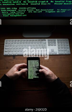 Phone, programmer hands and data screen with software for hacking crime or cyber security, download or virus. Hacker, programming and thief with Stock Photo