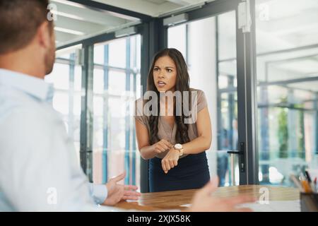 Business, woman and scolding with late employee, time management and man undermining female manager. Workplace, crisis and punctuality issue with Stock Photo