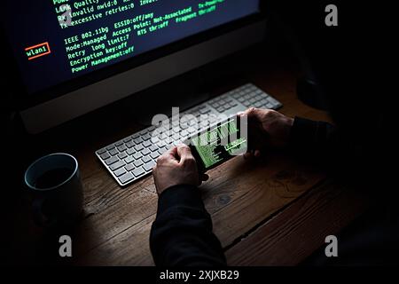 Phone, programmer hands and code screen with software for hacking crime or cyber security, download or virus. Hacker, person and thief with digital Stock Photo