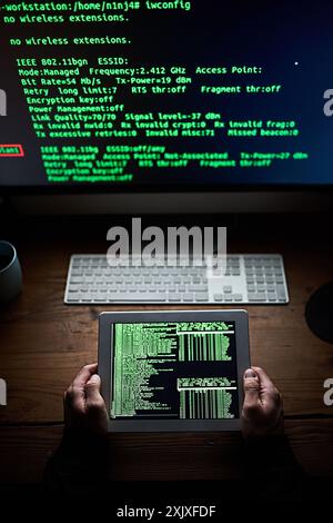 Hacker, hands or tablet at night with data, online scam or programming for access. Man, cyber crime or operating system on technology for virus upload Stock Photo