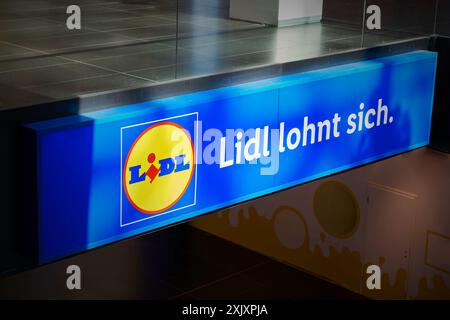 Illuminated sign for the Lidl discount grocery store in the city center of Leipzig in Germany Stock Photo