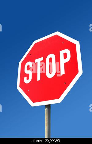 Stop sign in front of blue sky Stock Photo