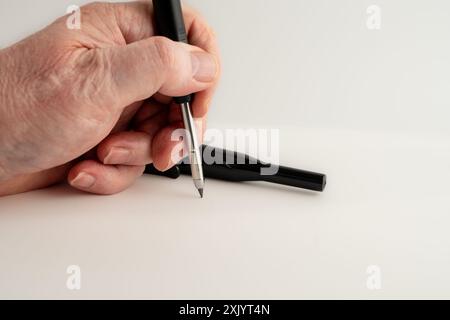 carpenter holding a mechanical pencil used for woodworking isolated on a white background Stock Photo