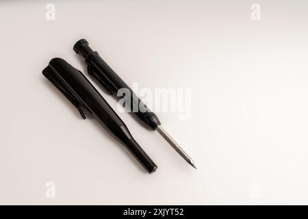 black mechanical pencil and case used for woodworking isolated on a white background Stock Photo